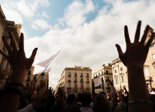 Hands raised during a protest in a city square