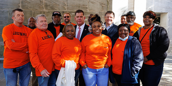 Secretary Walsh stands with a group of workers