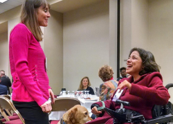 ODEP Senior Policy Advisor Nadia Mossburg (right) with her service dog Watson talk with Illinois State Sen. Laura Fine at the Women in Government Annual Conference in October 2018. 