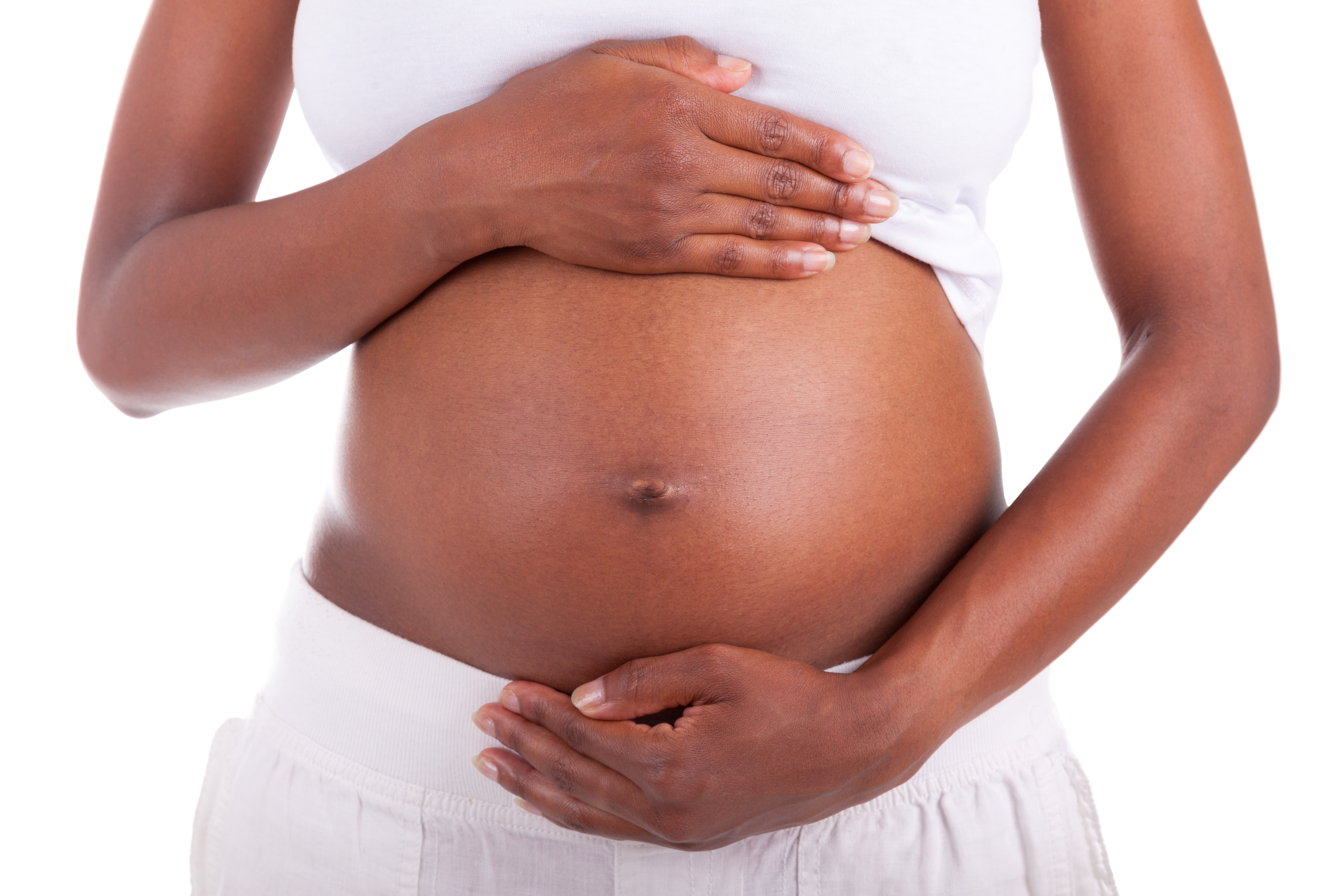 A pregnant black woman holding her stomach.