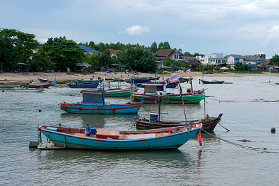 Thai fishing village with several boats in the water