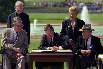 President George H.W. Bush signs the Americans with Disabilities Act on July 26, 1990.
