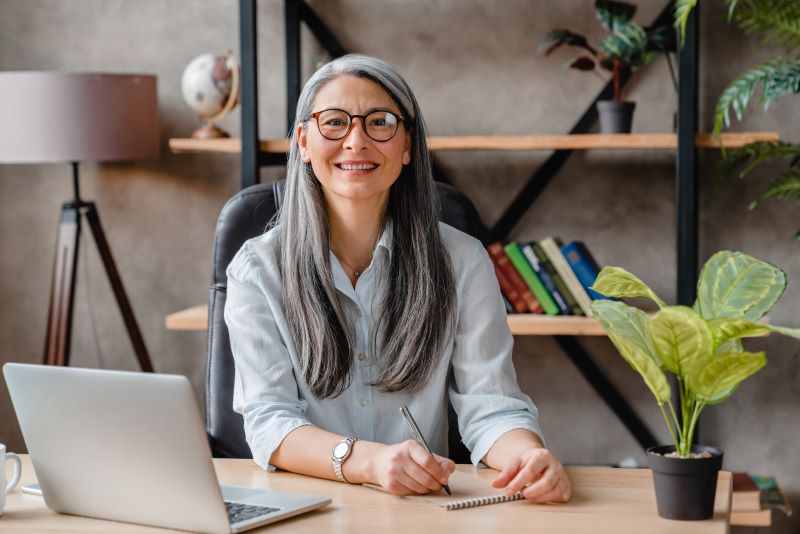 woman sitting at an office desk and working with a computer