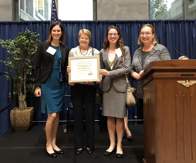 Representatives of the Office of the Solicitor accept an award for their pro bono efforts.