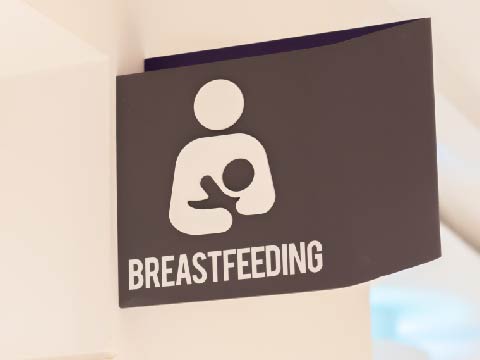 Photo of a nursing room, with a sign reading