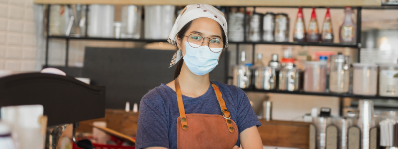 A worker stands in a restaurant.