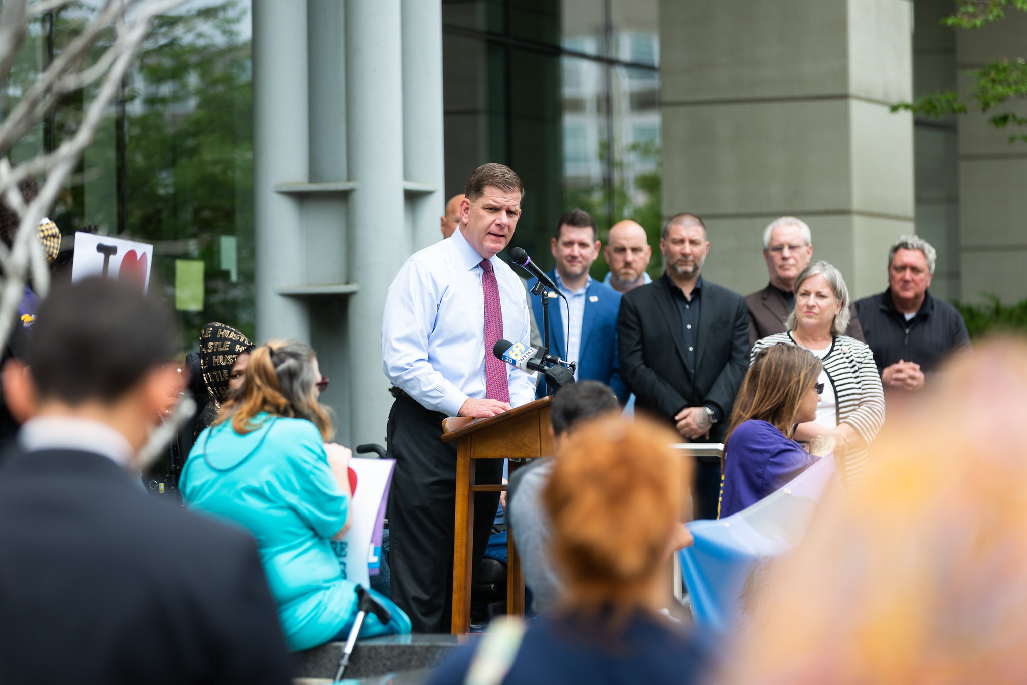 Secretary Marty Walsh stands in front of a crowd  of caregivers and activists speaking about the importance of investing in our care economy. 