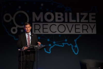 Secretary Walsh at a recovery event delivering remarks. Mobilizing Recovery banner behind him.