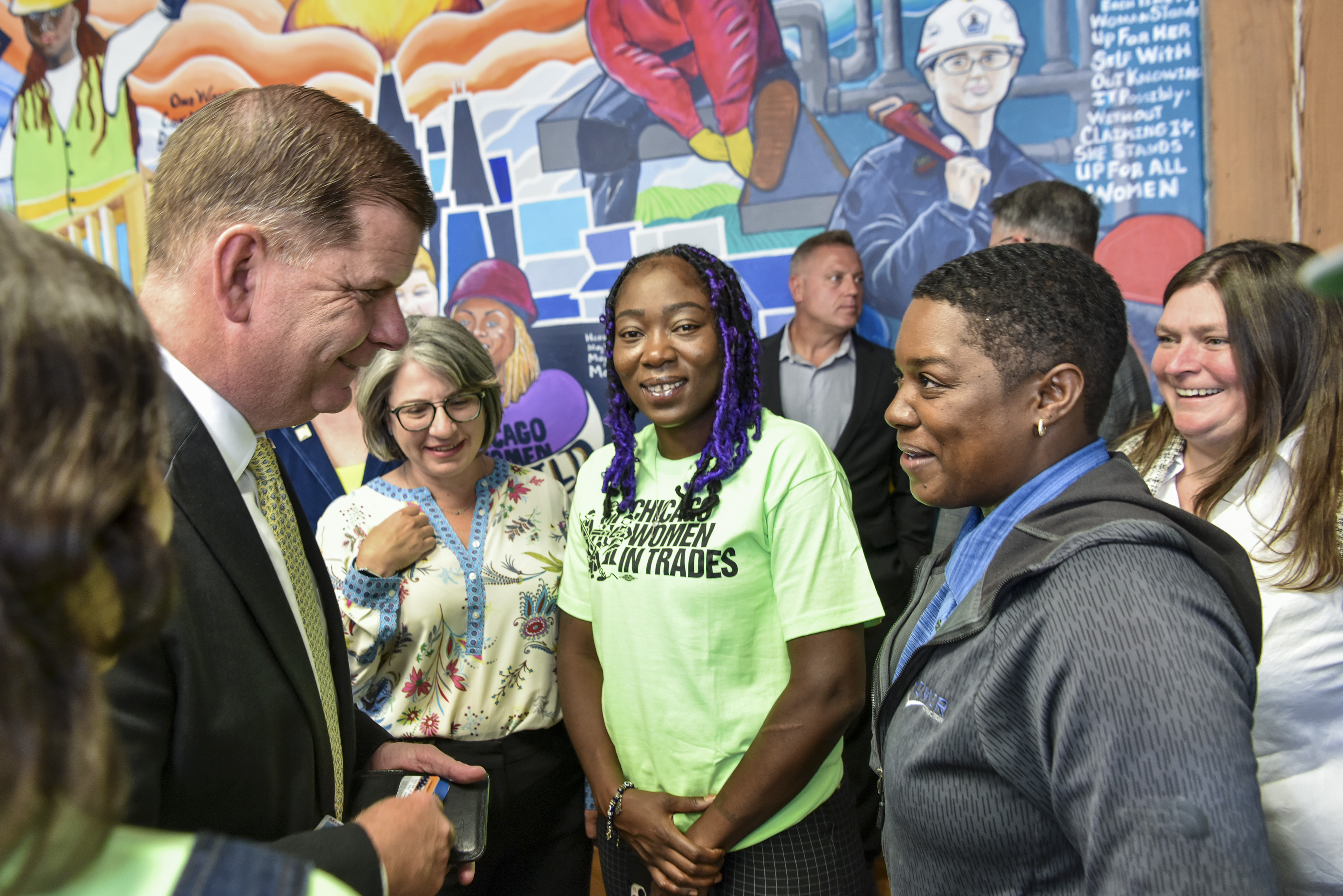 Secretary Walsh stands with a group of grantees.