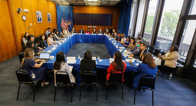 Acting Secretary of Labor Julie Su hosts a roundtable with AA and NHPI leaders to discuss how to better protect, train and empower AA and NHPI workers. This photo shows everyone in the meeting, sitting around tables arranged in a rectangle.