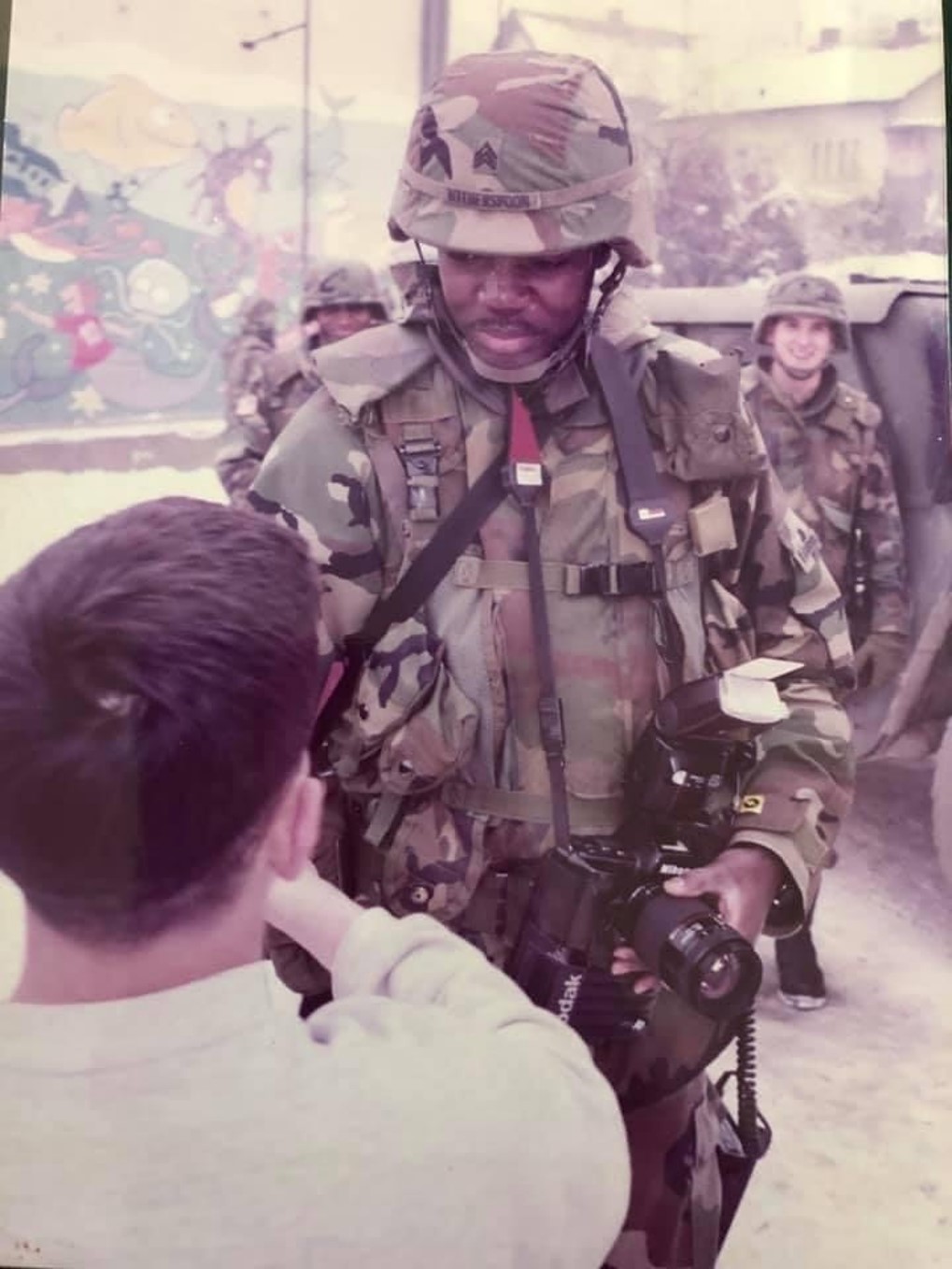 Derrick Witherspoon in Bosnia speaking with a child.