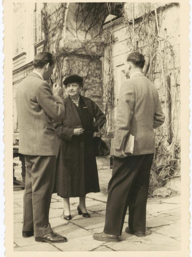 Frances Perkins stands outside speaking with two male delegates to the 1952 International Labor Organization conference in Geneva.  