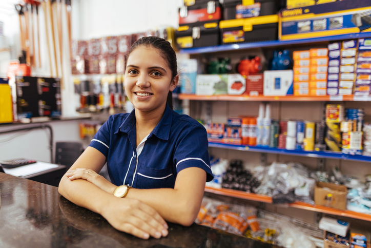 Young woman cashier in a hardware store