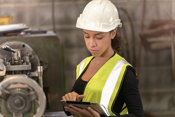 female construction worker looking at clipboard