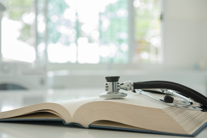 A picture of stethascope sitting on a book in a sterile room.