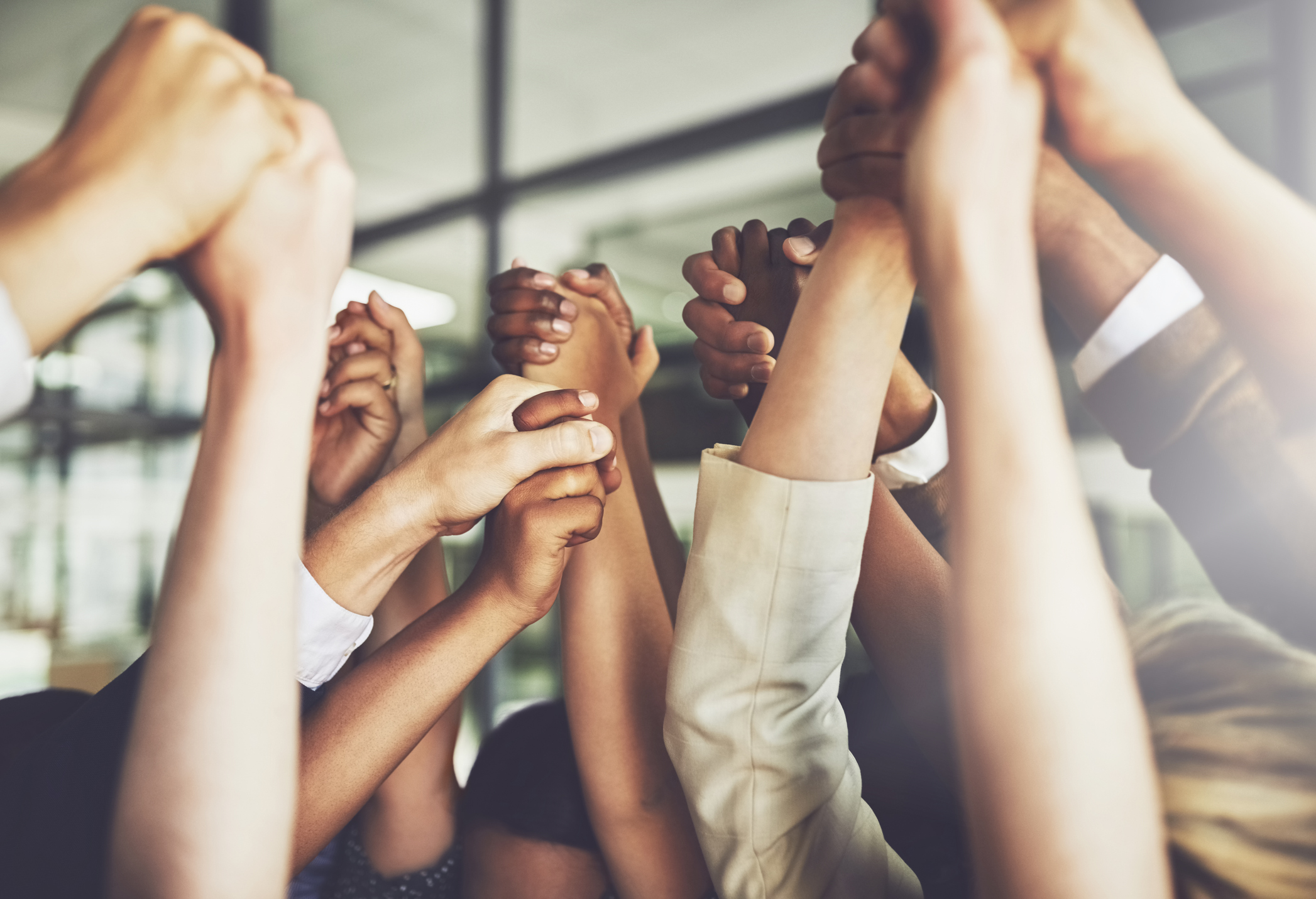 A group of hands high-fiving.