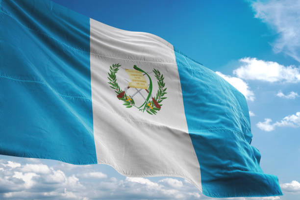 Guatemalan flag flies in the blue sky.