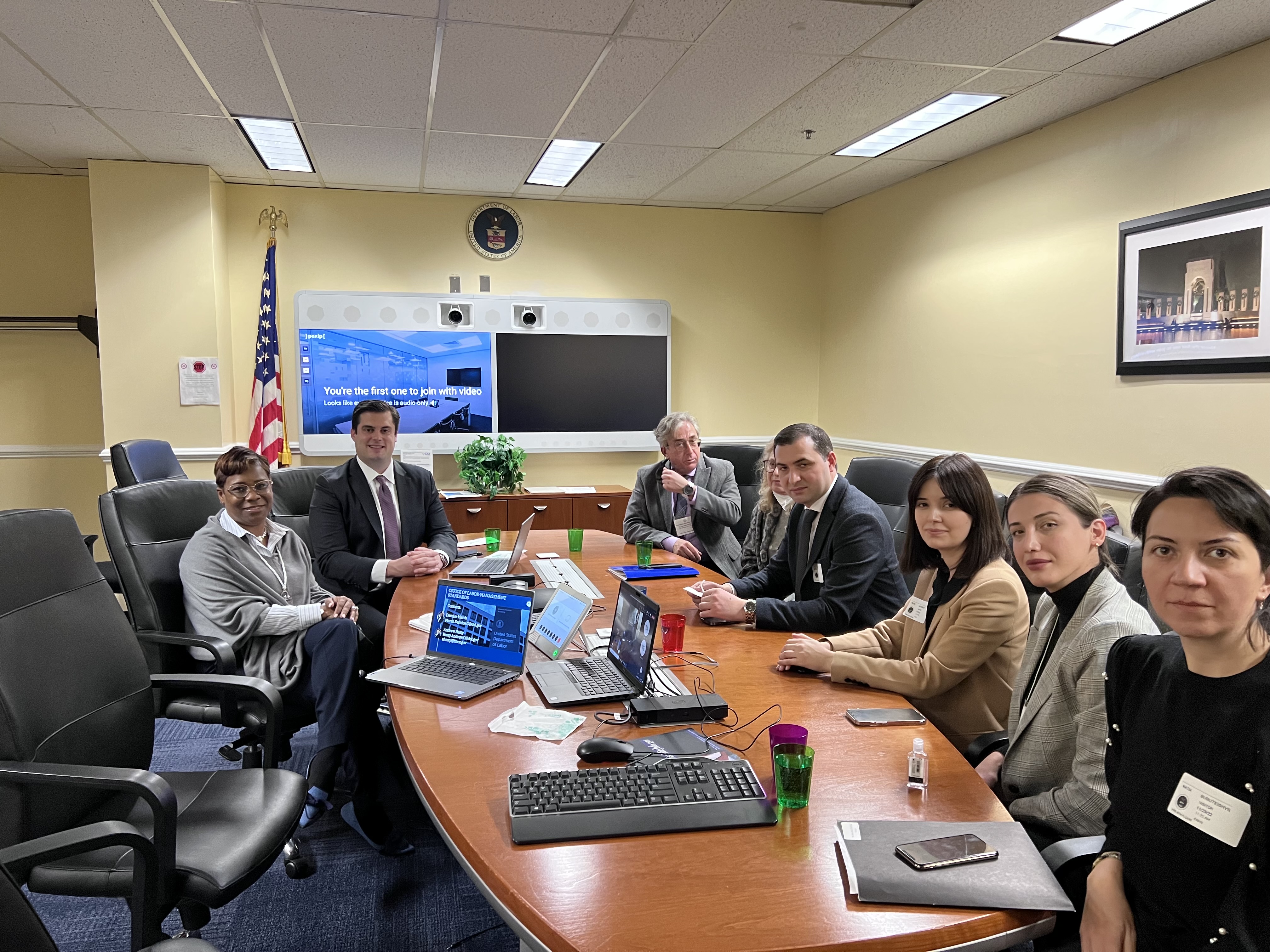 A few members of the Office of Labor-Management Standards seated around long oval table