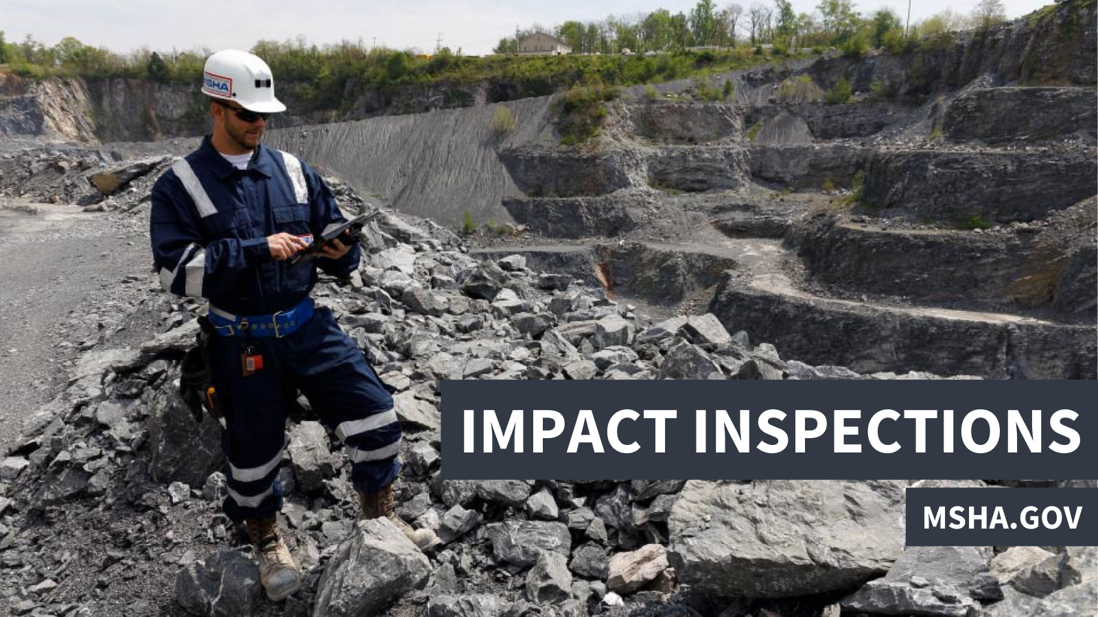An MSHA inspector uses a tablet while standing on a pile of rocks at an outdoor mining site. "Impact inspections, msha.gov"