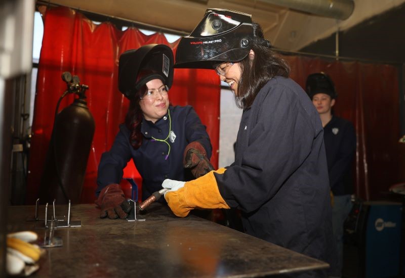 Acting Labor Secretary Julie Su learns to weld during a visit to Chicago Women in Trades, an organization that prepares women for good jobs 