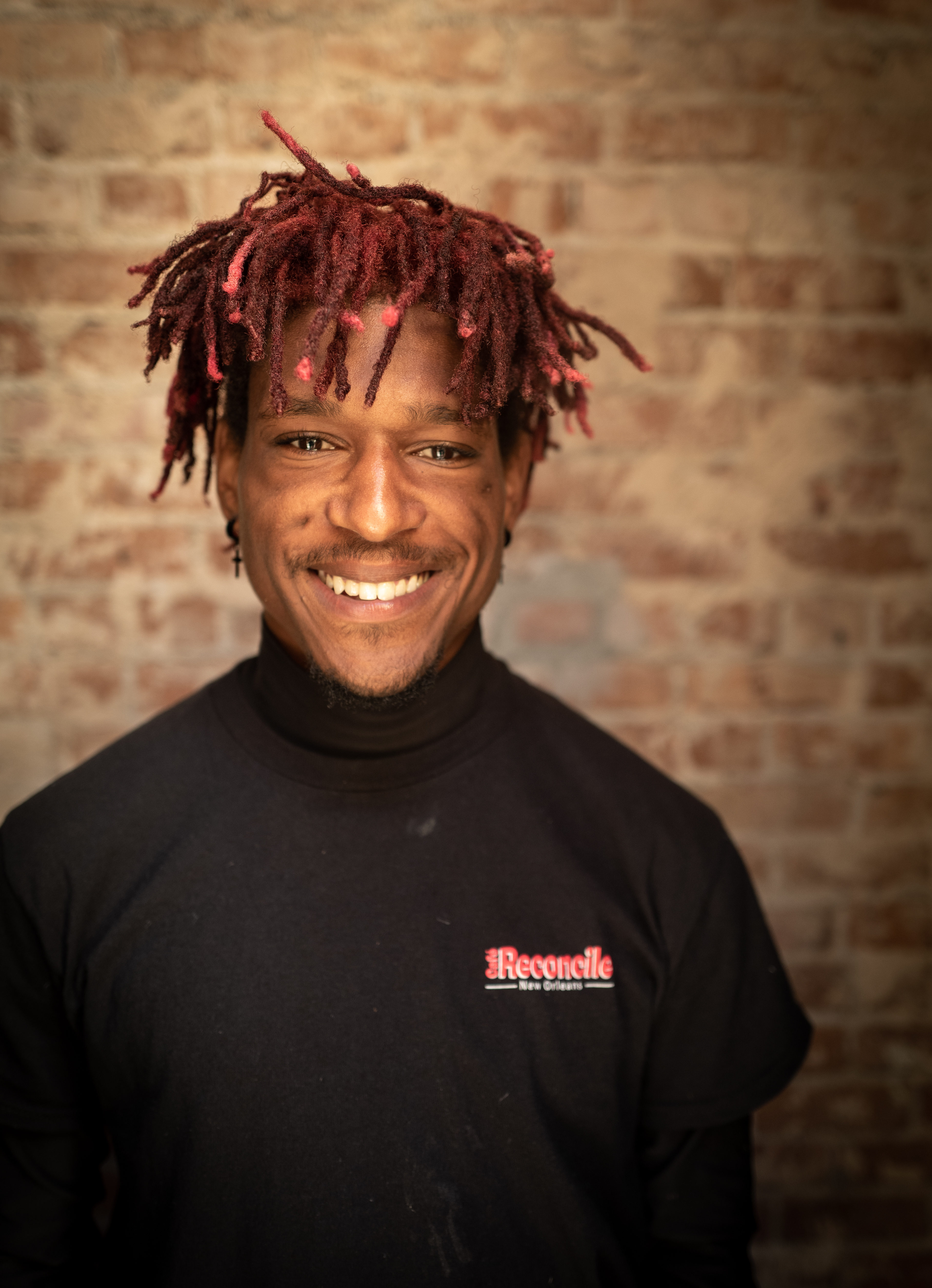 Headshot of STRIVE graduate, Jacob, in a black chef jacket.