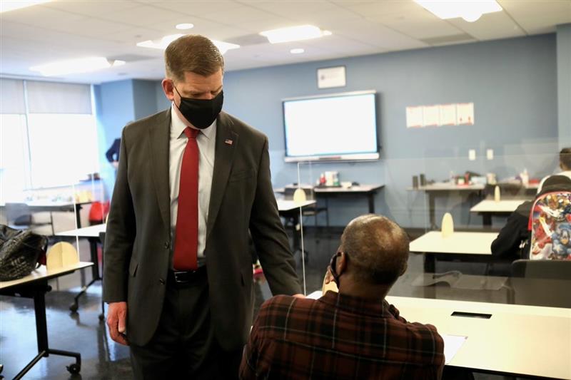 Secretary Walsh meets with a staff member at the Department of Employment Services in Washington, D.C.