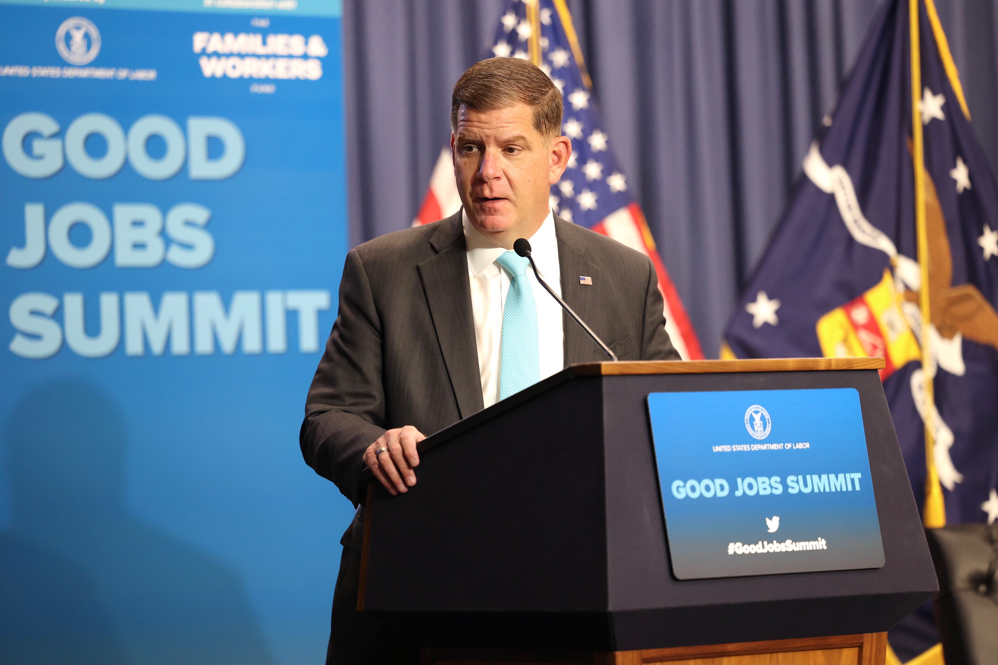 Secretary Walsh stands at the podium at the Good Jobs Summit