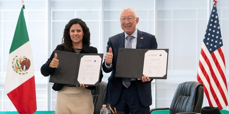 U.S. Ambassador Ken Salazar and Luisa María Alcalde, Mexico’s secretary of labor and social welfare, hold up signed documents during the ceremony to launch the pilot program.