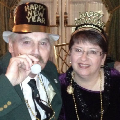 Trish Gallagher and her husband Tom wearing New Year's Eve hats.
