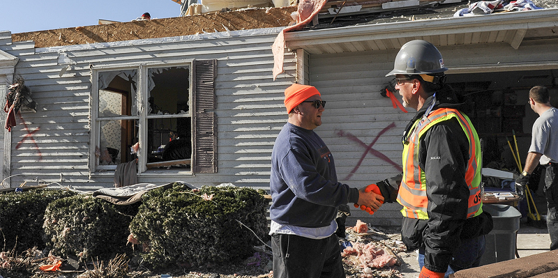 An OSHA inspector visits a home destroyed by a tornado to check on workers during cleanup and recovery efforts. 