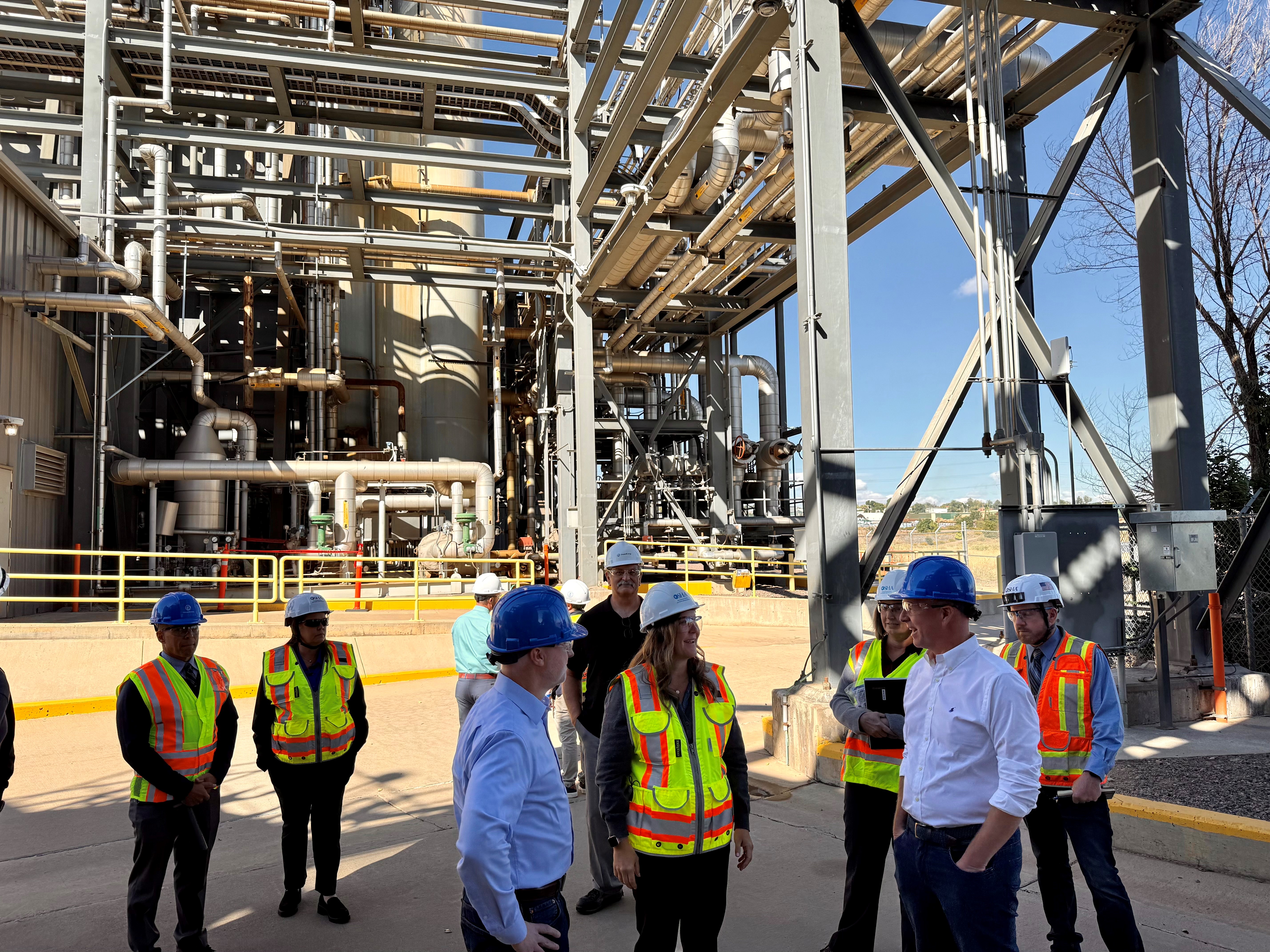 OSHA representatives tour an energy plant with workers and management.