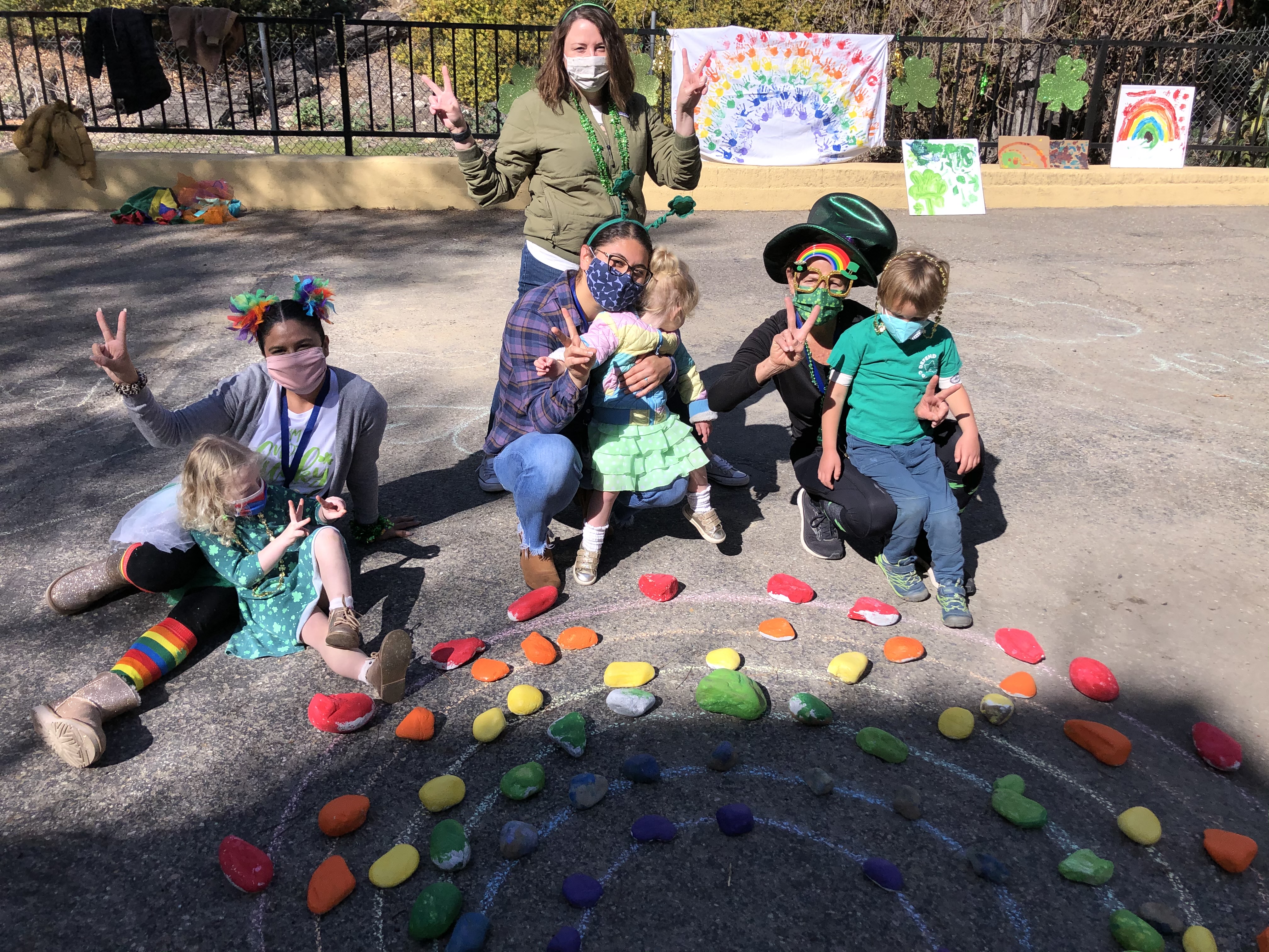 Image of Jessica Derby with three other early childhood experts at a daycare with a few children. 