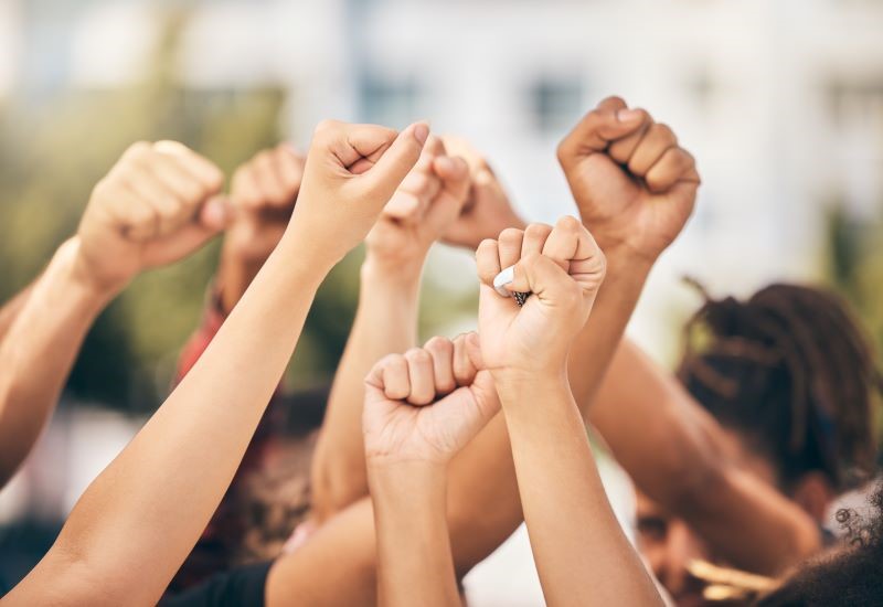 A group of raised fists in the air.