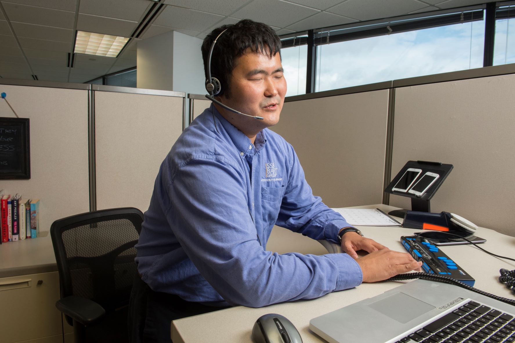 An employee with a disability working at a desk.