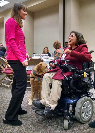 ODEP Senior Policy Advisor Nadia Mossburg (right) with her service dog Watson talk with Illinois State Sen. Laura Fine at the Women in Government Annual Conference in October 2018. 