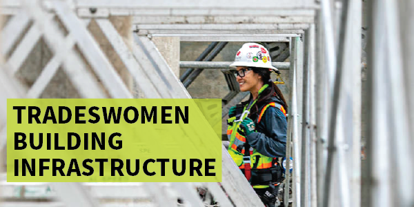 A tradeswoman at a construction site wearing a hardhat, high visibility vest and other safety gear. "Tradeswomen Building Infrastructure."