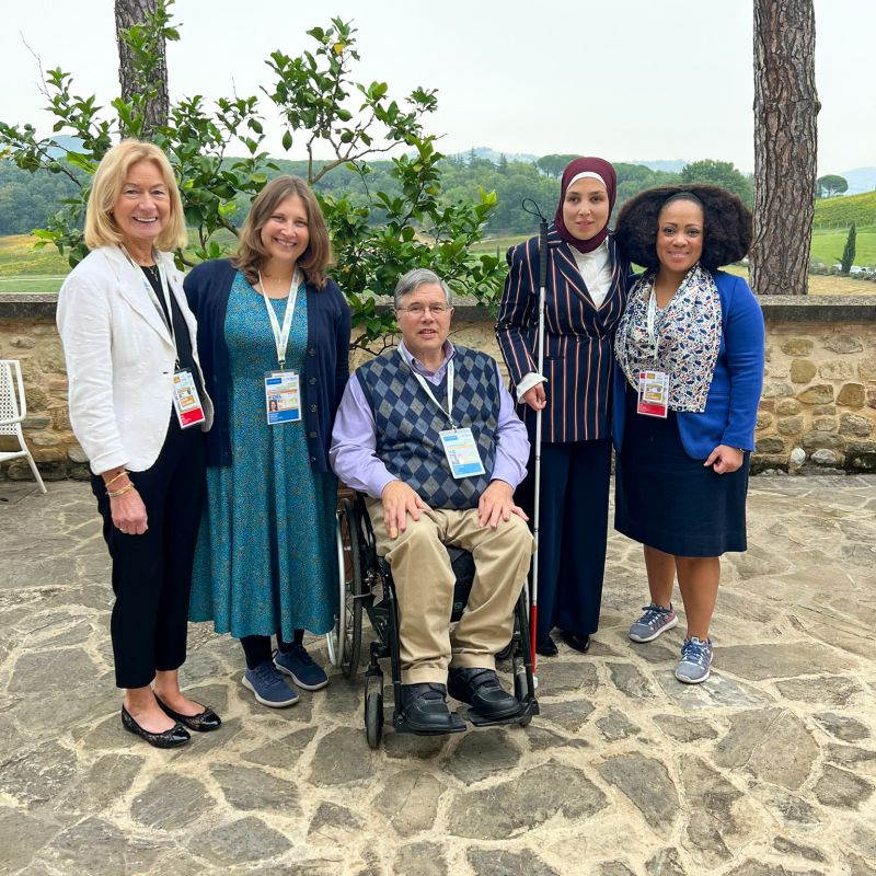 Assistant Secretary of Labor for Disability Employment Policy Taryn M. Willams with four other attendees of the G7 Ministerial Meeting on Inclusion and Disability in Umbria, Italy, in October 2024. Two people in the photo have visible physical disabilities.    