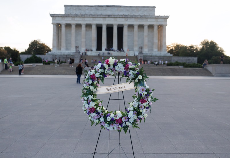 A wreath with the words "Workers Memorial" in front of the Lincoln Memorial in Washington, D.C.