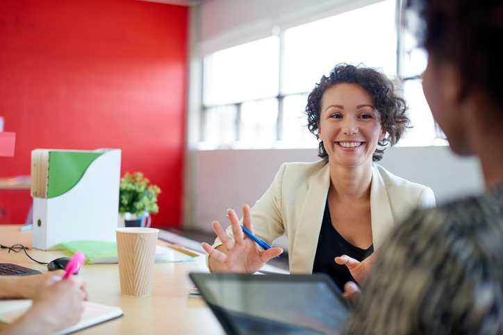 A woman business owner speaks with a customer.