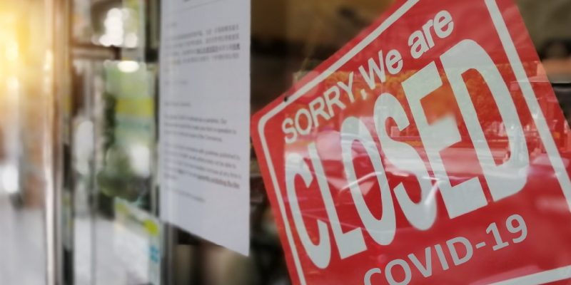 Photo: A storefront has a closed sign.
