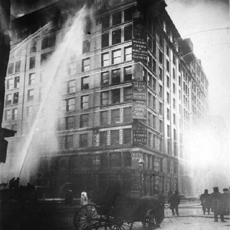 A black and white photo shows firefighters responding to the Triangle factory fire in 1911.