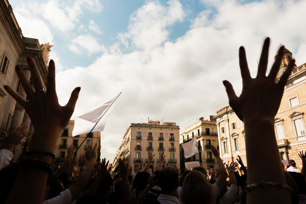 Hands raised during a protest in a city square