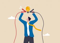 Graphic of a man holding a light bulb over his head with jumper cables.