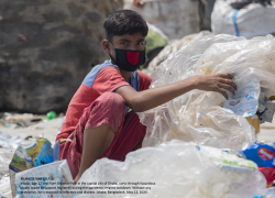 Miajul, age 12 and from Shyamol Palli in the capital city of Dhaka, sorts through hazardous plastic waste to support his family during the pandemic-related lockdown.