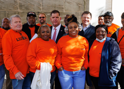 Secretary Walsh stands with a group of workers