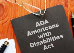  A folder on a table reads ADA American with Disabilities Act