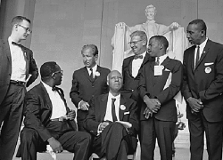 Black-and-white photo of seven March on Washington leaders including A. Philip Randolph and John Lewis in front of the Lincoln Memorial. 