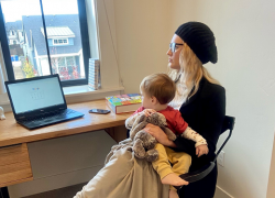 Nichole and her son sit at her desk