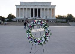 A wreath with the words "Workers Memorial" in front of the Lincoln Memorial in Washington, D.C.