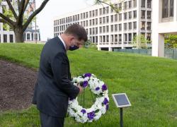 Secretary Walsh lays a wreath at a Workers Memorial plaque at the Department of Labor headquarters.